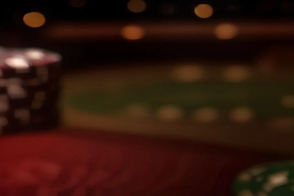 Casino chips and blurred roulette